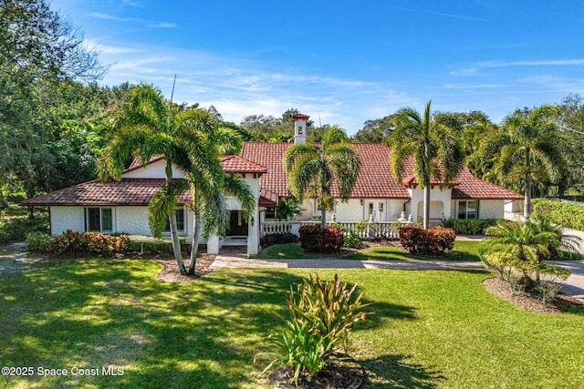 mediterranean / spanish-style home featuring a front yard