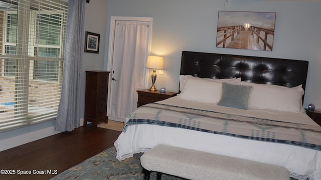 bedroom with hardwood / wood-style flooring and multiple windows