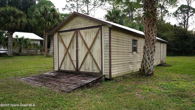 view of outbuilding featuring a lawn