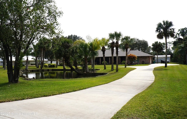 view of home's community featuring a yard and a water view