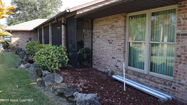 view of home's exterior with a yard and a sunroom