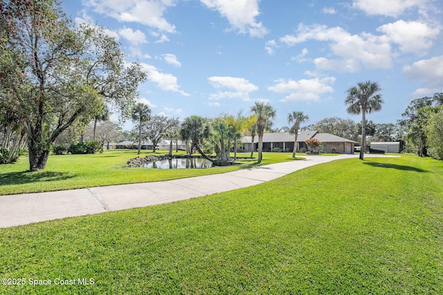 view of community with a yard and a water view