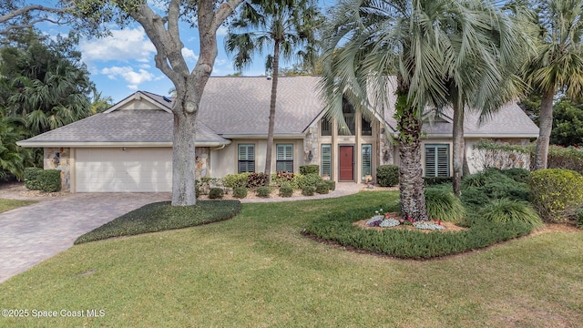 view of front of home with a garage and a front yard