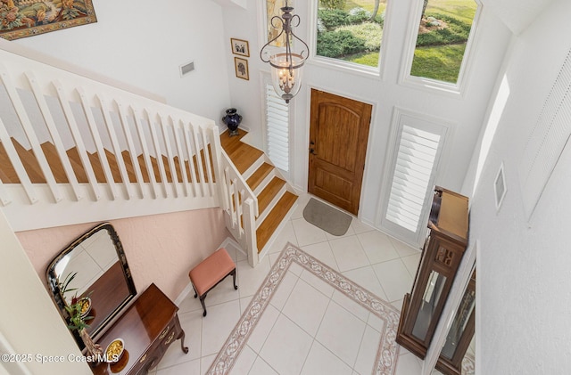 entrance foyer featuring tile patterned flooring and a towering ceiling