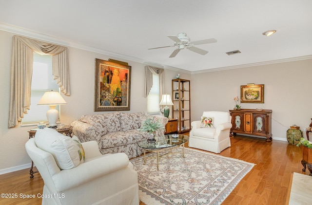 living room with ceiling fan, crown molding, and hardwood / wood-style floors