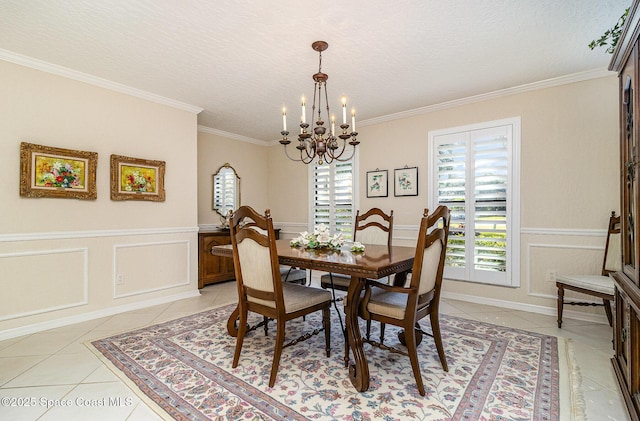 dining area with an inviting chandelier, light tile patterned flooring, and crown molding