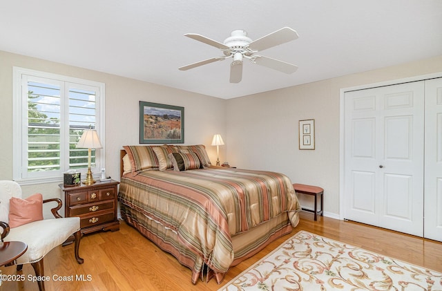 bedroom featuring ceiling fan, a closet, and light hardwood / wood-style floors