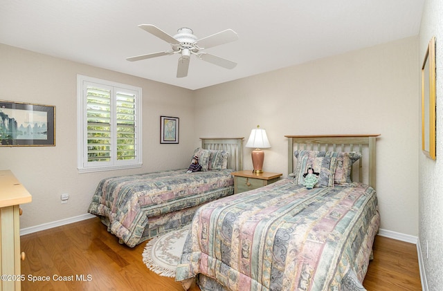 bedroom with ceiling fan and hardwood / wood-style flooring