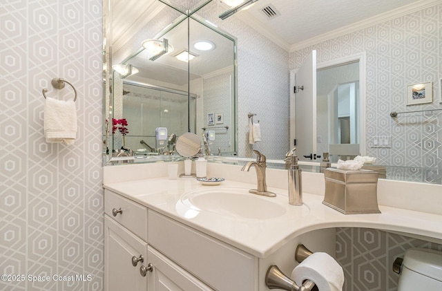 bathroom featuring toilet, vanity, and ornamental molding