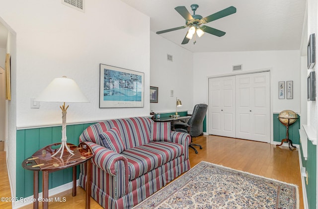 living room with vaulted ceiling, ceiling fan, and hardwood / wood-style floors