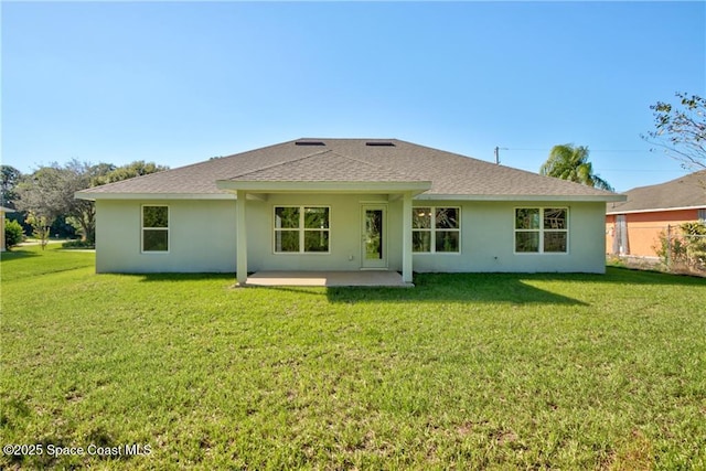 back of property featuring a patio area and a lawn