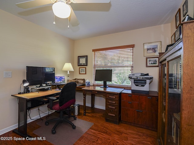 home office with ceiling fan and dark hardwood / wood-style flooring