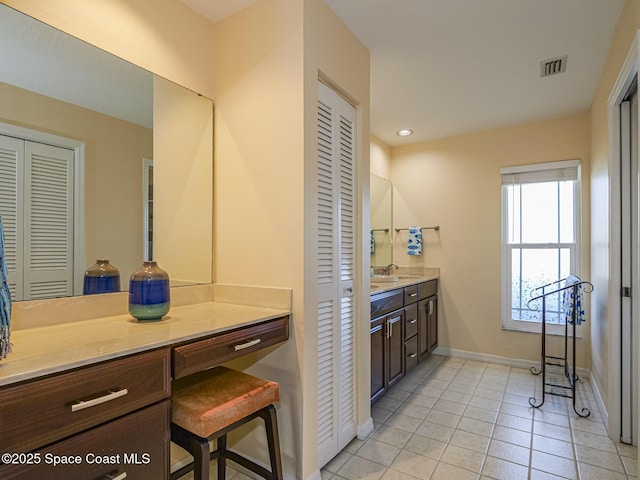 bathroom with tile patterned flooring and vanity