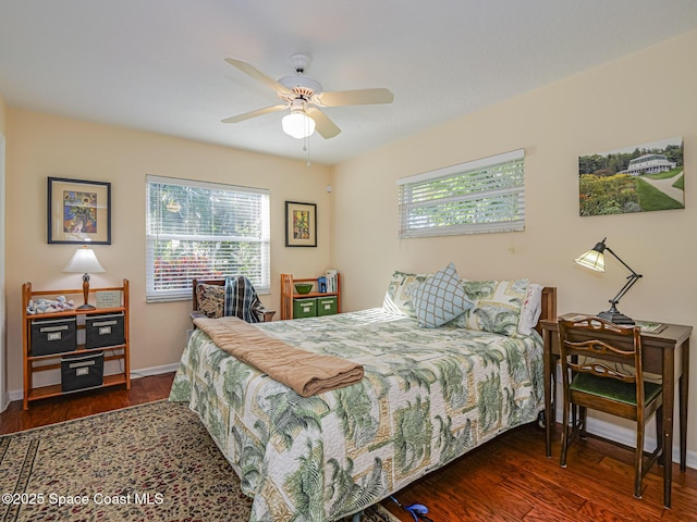 bedroom with dark hardwood / wood-style flooring and ceiling fan