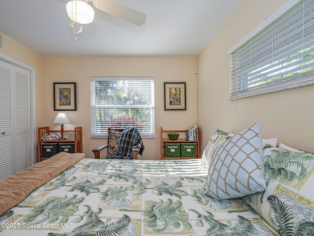 bedroom with ceiling fan and a closet