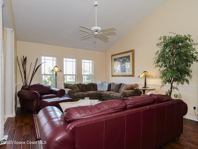 living room with decorative columns, lofted ceiling, dark hardwood / wood-style floors, and ceiling fan