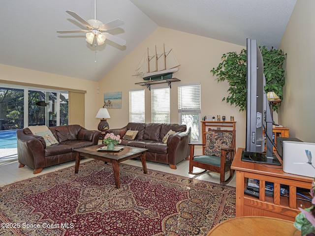 living room featuring tile patterned flooring, high vaulted ceiling, and ceiling fan