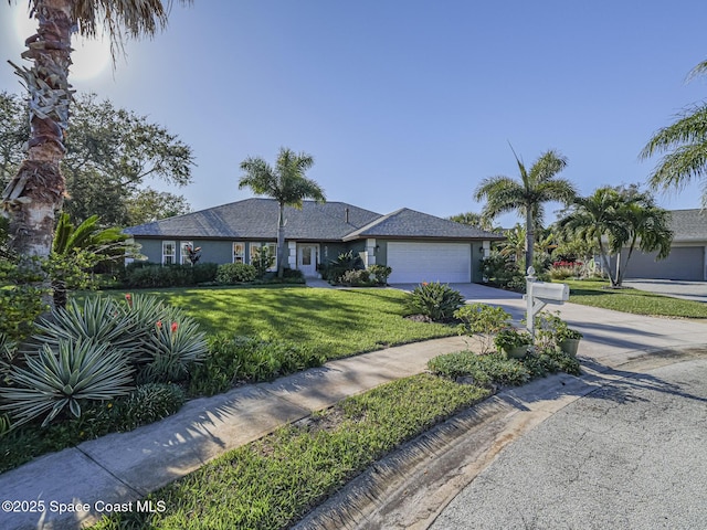 ranch-style house featuring a garage and a front lawn