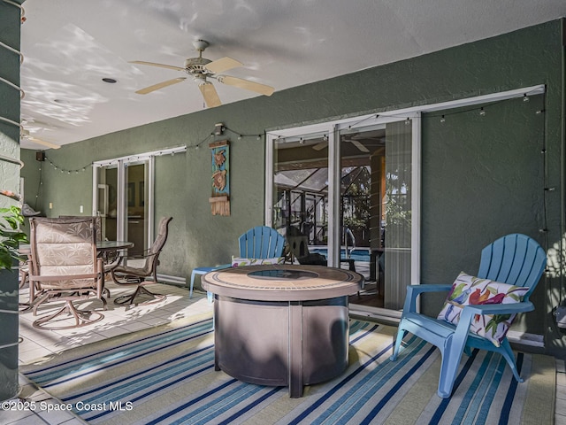 view of patio / terrace featuring ceiling fan and a fire pit