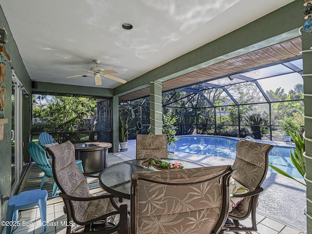 view of patio featuring ceiling fan and a lanai