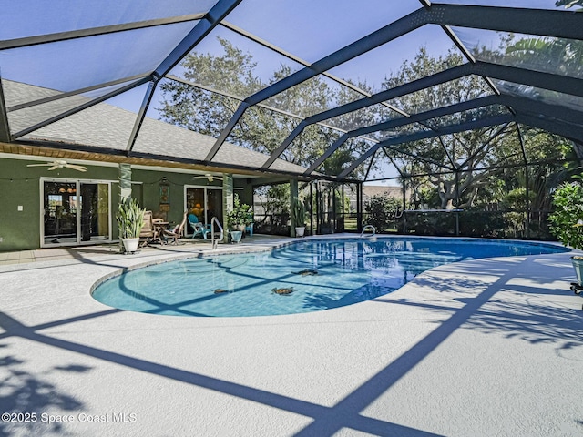 view of pool featuring a lanai, a patio area, and ceiling fan