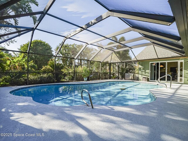 view of pool with a lanai and a patio