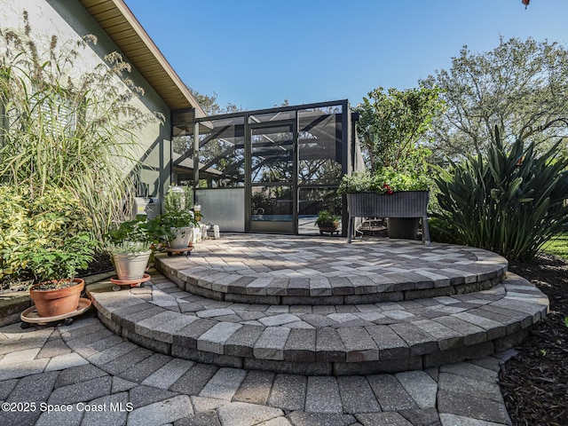 view of patio with glass enclosure