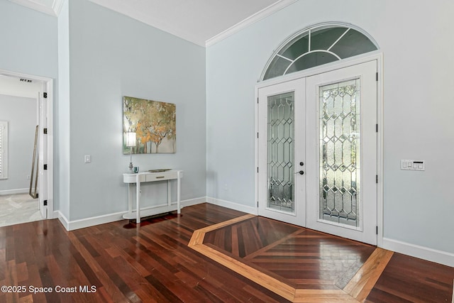 entrance foyer with french doors, baseboards, wood finished floors, and ornamental molding