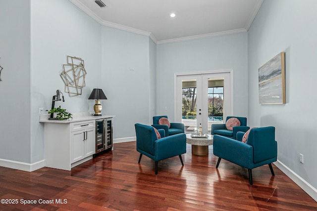 sitting room featuring wine cooler, french doors, dark wood-type flooring, and ornamental molding