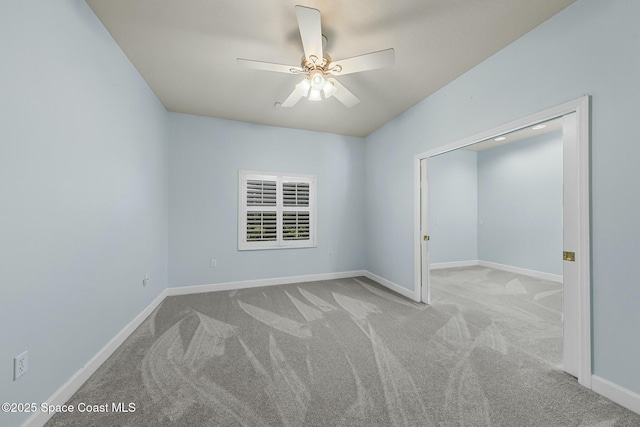 unfurnished bedroom with a ceiling fan, carpet, and baseboards