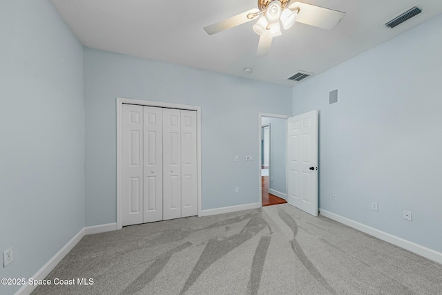 unfurnished bedroom with carpet, visible vents, and baseboards