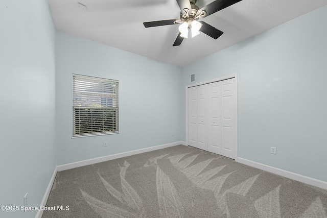 unfurnished bedroom featuring a closet, visible vents, baseboards, and carpet floors