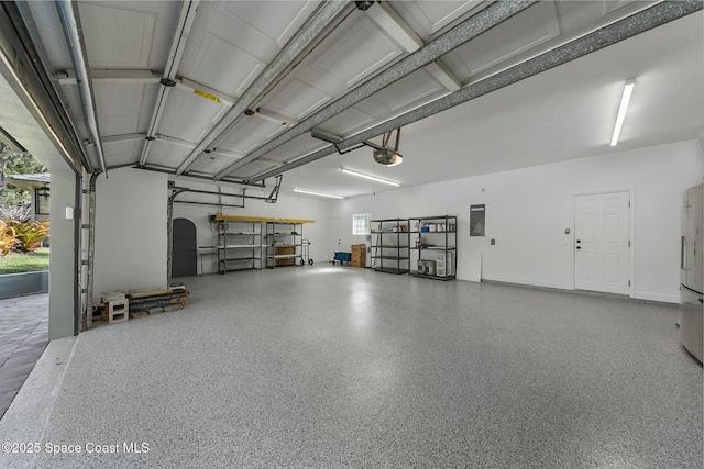 garage featuring electric panel and a garage door opener