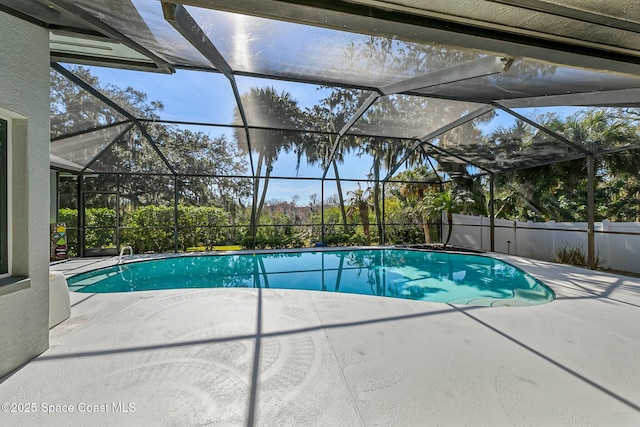 view of swimming pool with a patio, a fenced in pool, and a lanai