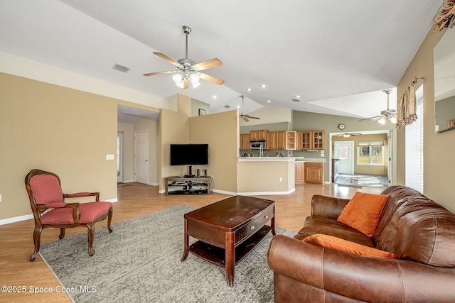 living room featuring vaulted ceiling and light wood-type flooring