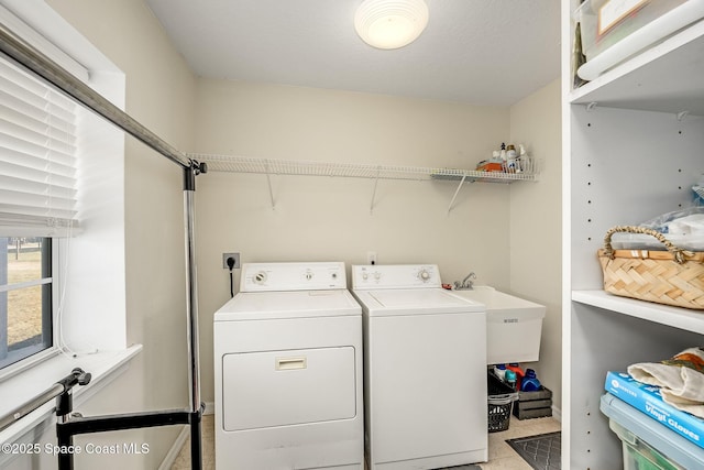 laundry area with washer and clothes dryer and sink