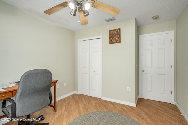 office space featuring ceiling fan, a textured ceiling, and light hardwood / wood-style flooring