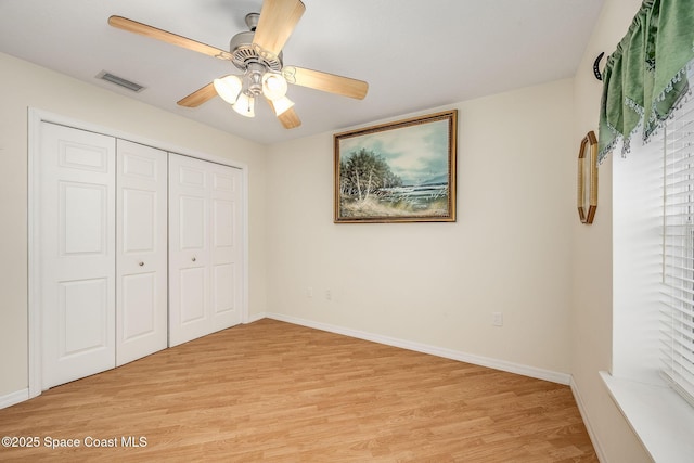 unfurnished bedroom with ceiling fan, a closet, and light hardwood / wood-style flooring