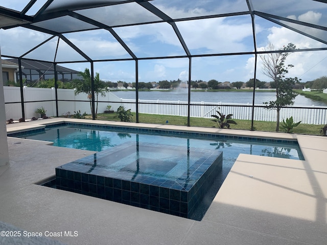 view of pool with a water view, a patio area, glass enclosure, and an in ground hot tub