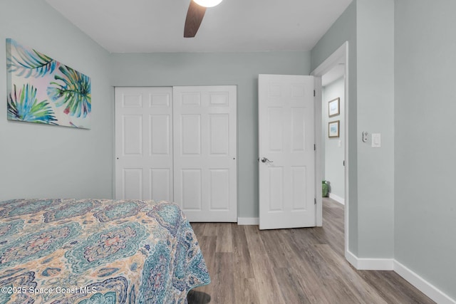 bedroom featuring ceiling fan, a closet, and hardwood / wood-style floors