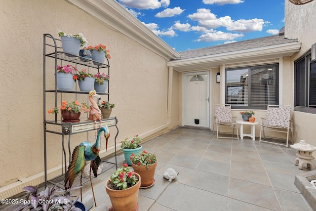 entrance to property with a patio area