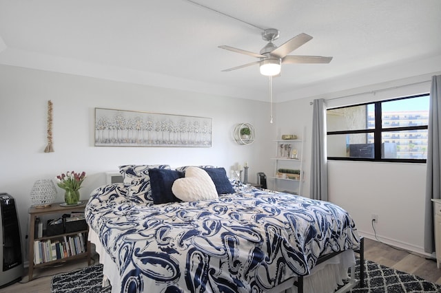 bedroom with ceiling fan and light hardwood / wood-style floors