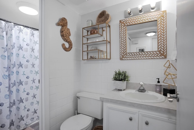 bathroom featuring toilet, vanity, tile walls, and a shower with curtain