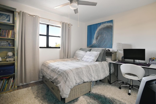 bedroom with ceiling fan and hardwood / wood-style flooring