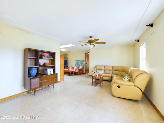 living room featuring ceiling fan and tile patterned floors