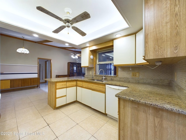 kitchen with sink, light tile patterned floors, dishwasher, kitchen peninsula, and white cabinets