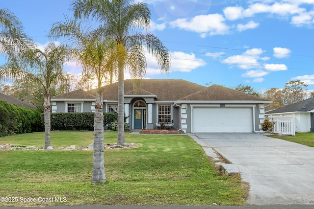 single story home featuring a lawn and a garage