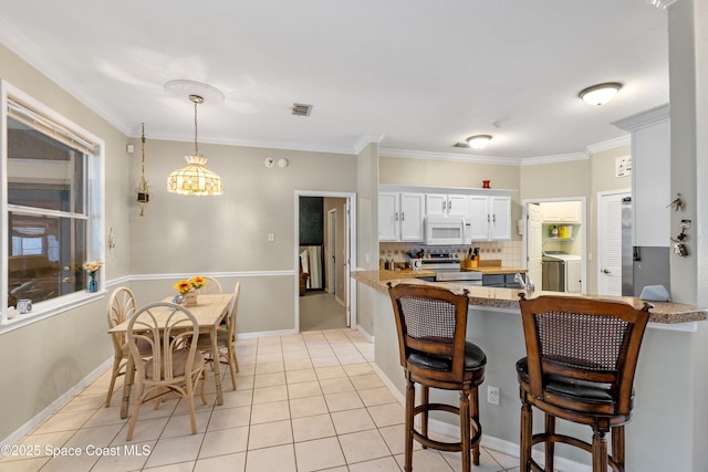 kitchen featuring crown molding, white cabinets, and electric stove