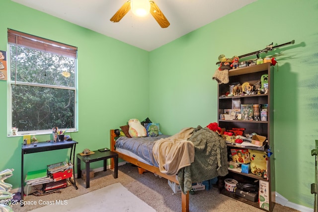 bedroom featuring ceiling fan and light carpet