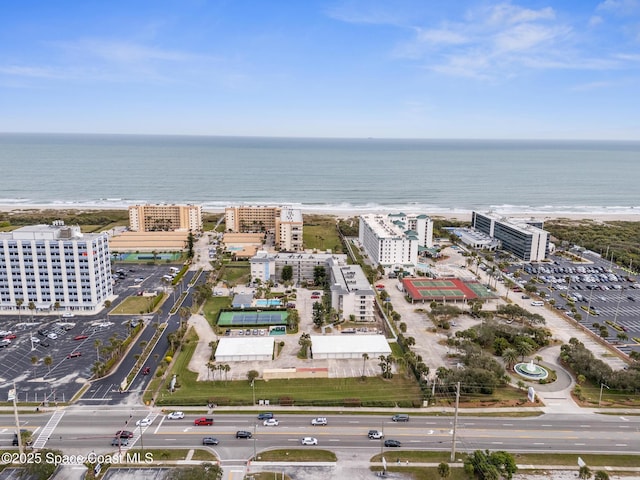 bird's eye view with a water view and a beach view